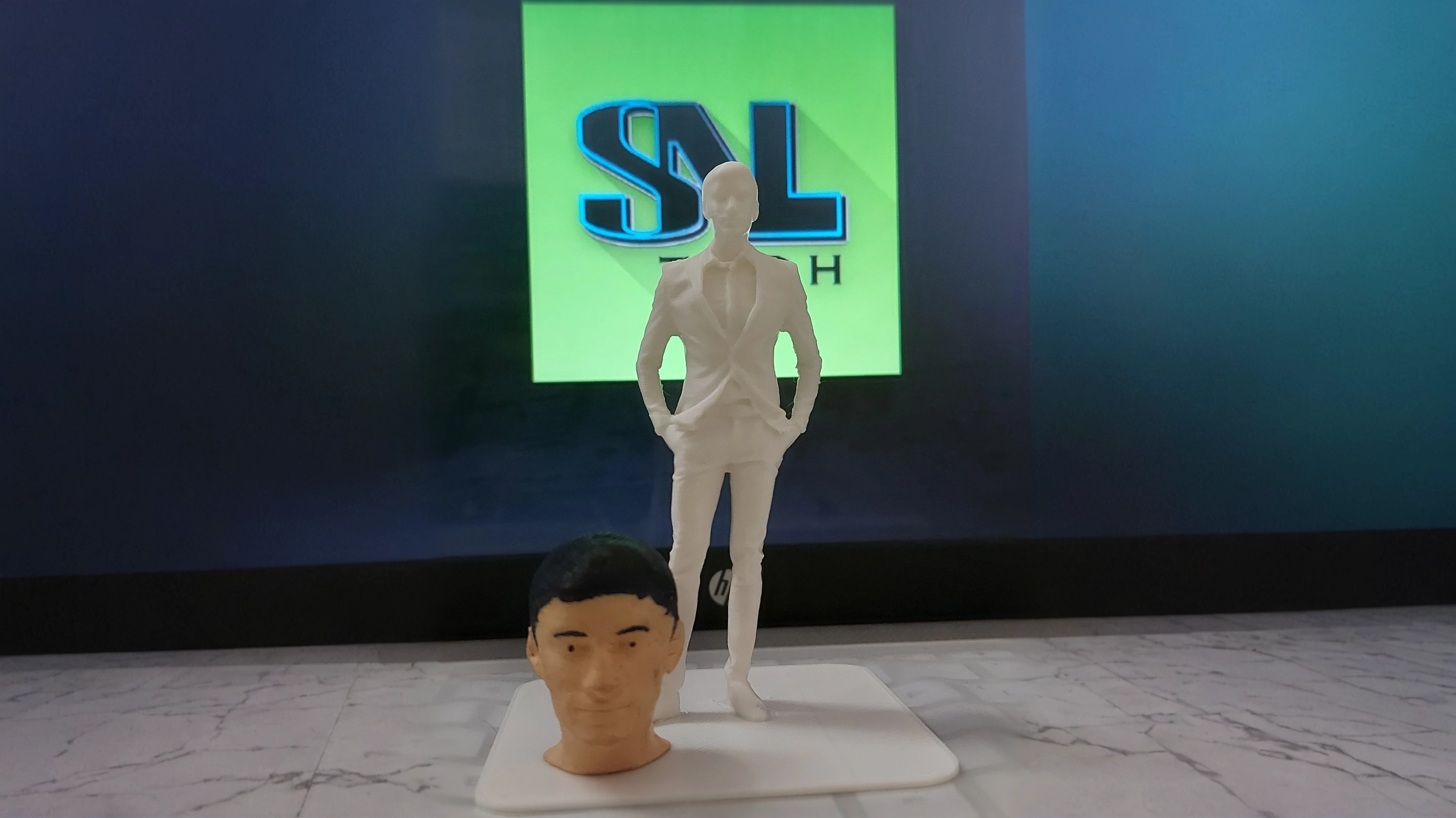 A small 3D-printed figurine of a person placed on a desk